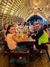 Friends sharing a meal at a long table in Chingu restaurant