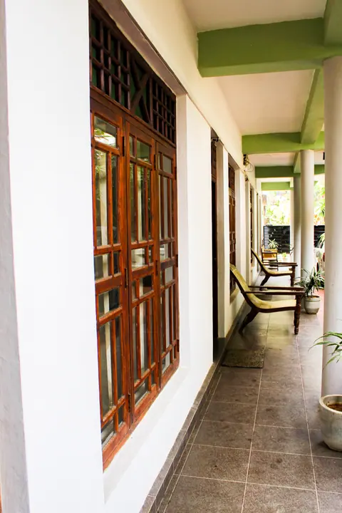 Long veranda lined with carved wooden windows